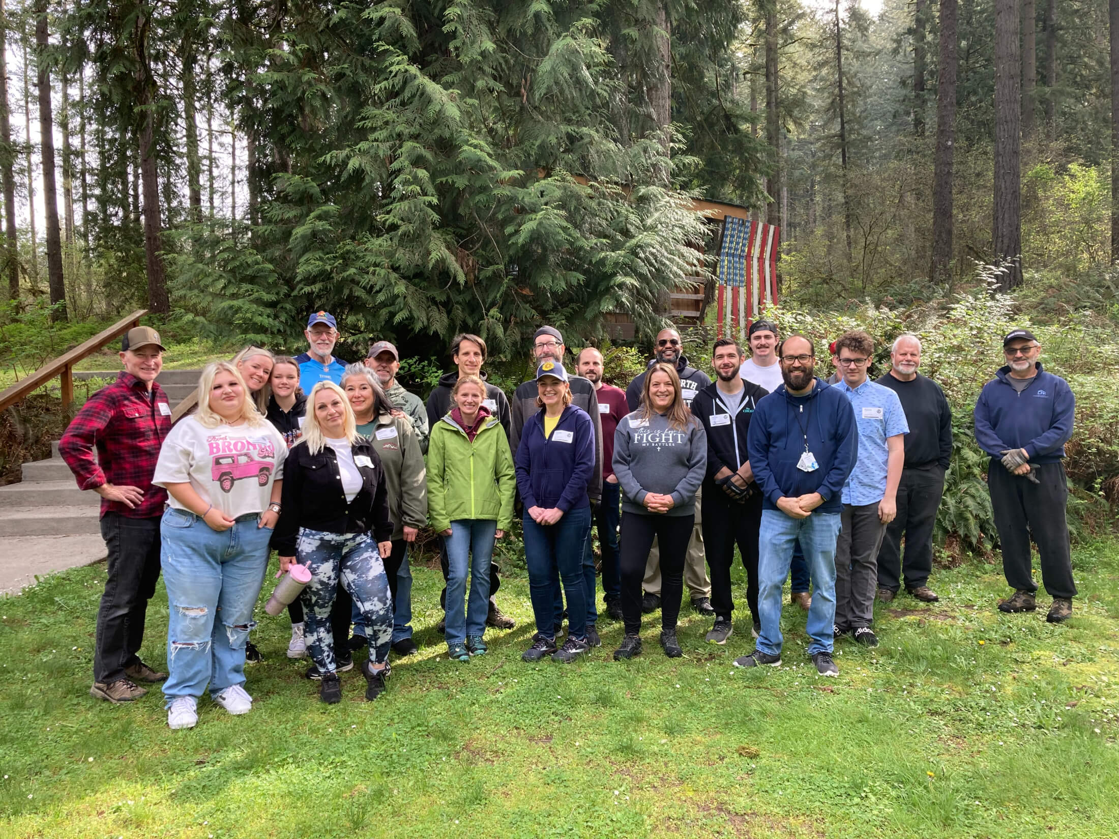 line of adults standing in front of treeline